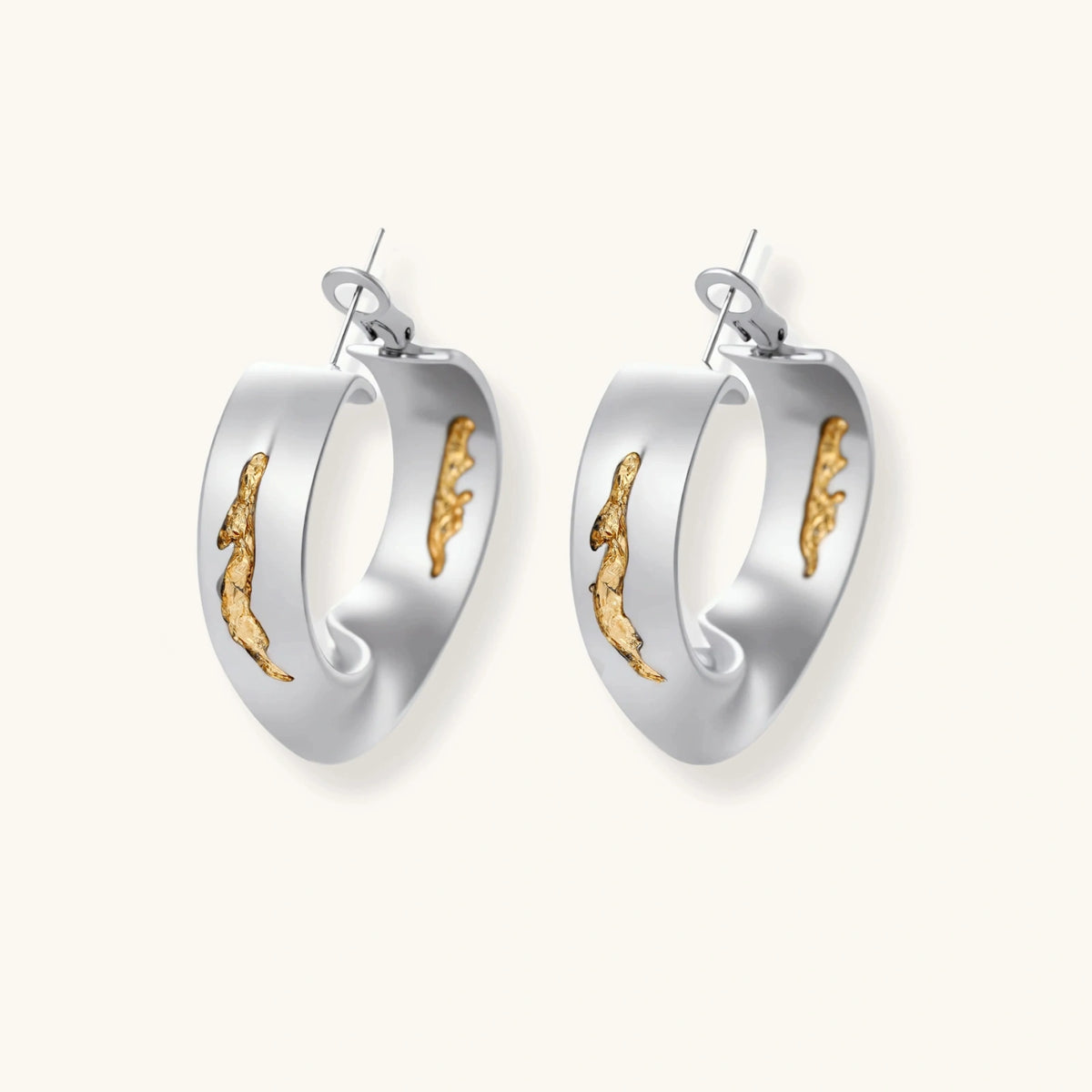 Silver hoop earrings with organic gold flowing accents, featuring eco-zinc alloy construction and secure posts.